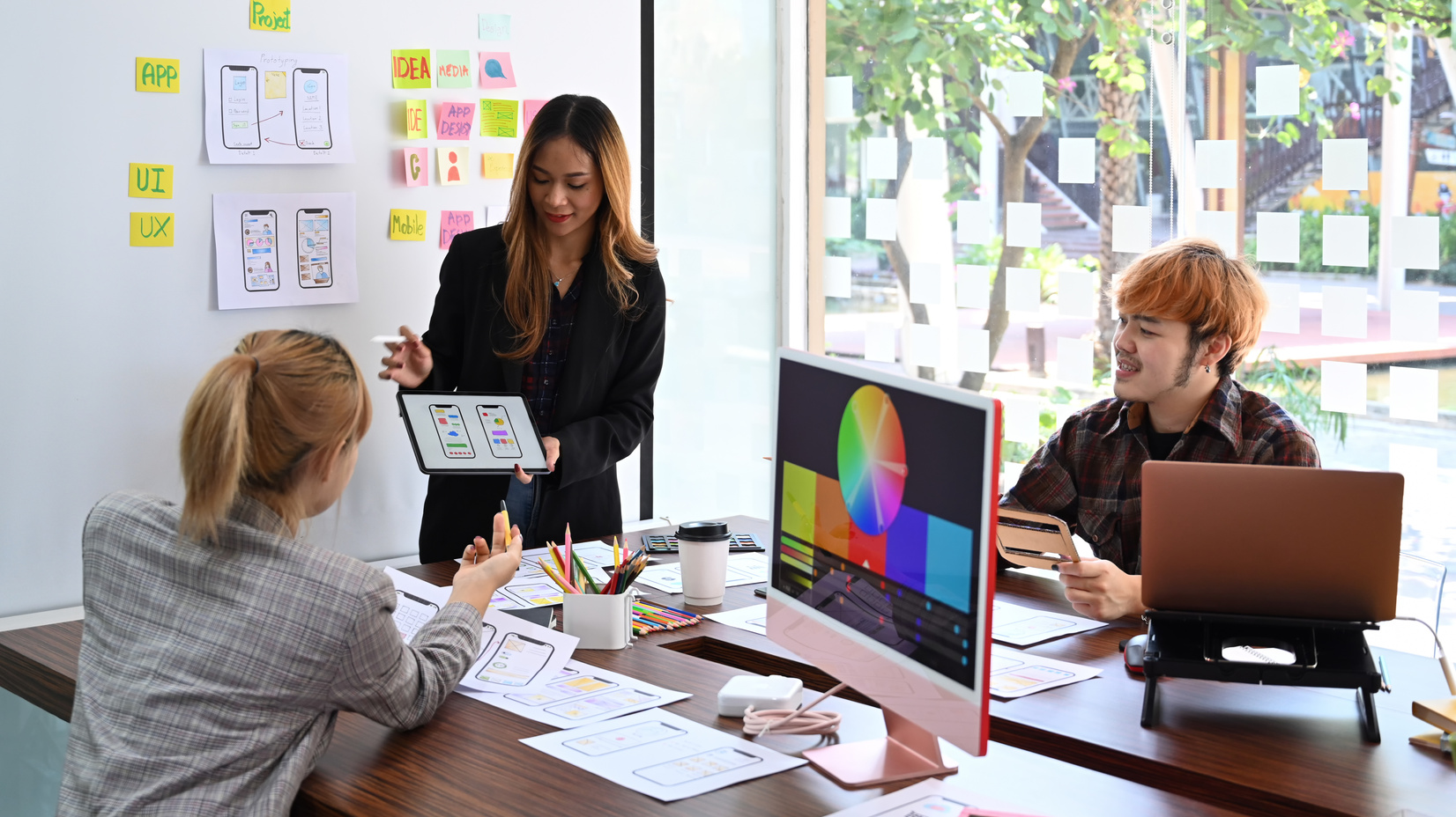 Female Website Designer Showing User Interface Design on Digital